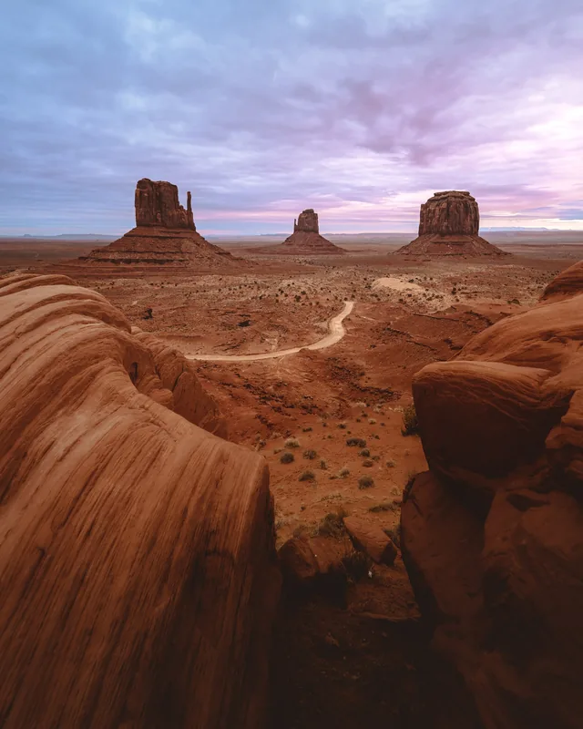 Red sandstone buttes under a pink evening sky